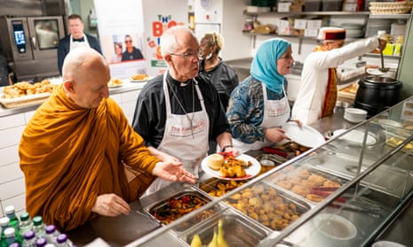 The Venerable Ajahn Amaro, the archbishop of Canterbury Justin Welby and Julie Siddiqi serve food as they join other faith leaders in taking part in the Big Help Out in London