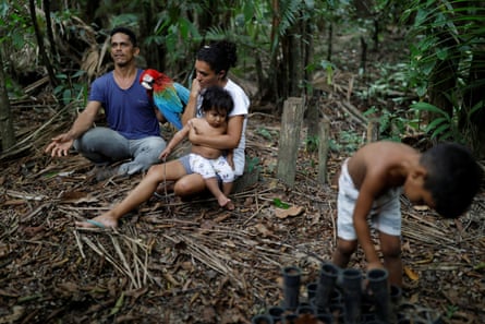 Vinicius Dos Santos sits next to his family as he talks to Reuters TV in Anapu in 2019 about the threat from loggers and stockbreeders.