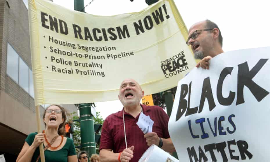 White people participate in a march on Tuesday organised by the Syracuse Peace Council to protest against racism and the murders of nine people in a black church in Charleston, South Carolina.