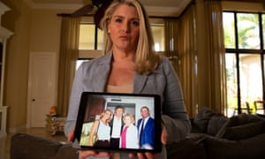 Amy Dorris at her home in Florida, holding an image of herself with Trump at the 1997 US Open.