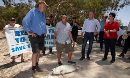NSW Labor leader Michael Daley is shown a dead Murray cod by Menindee locals in January