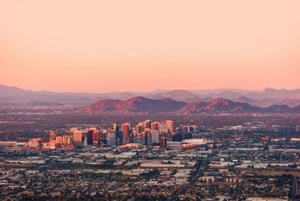 Phoenix Arizona with its downtown lit by the last rays of sun at the dusk.