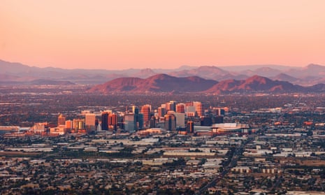 Phoenix Arizona with its downtown lit by the last rays of sun at the dusk.