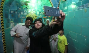 A woman takes a selfie inside the shrine