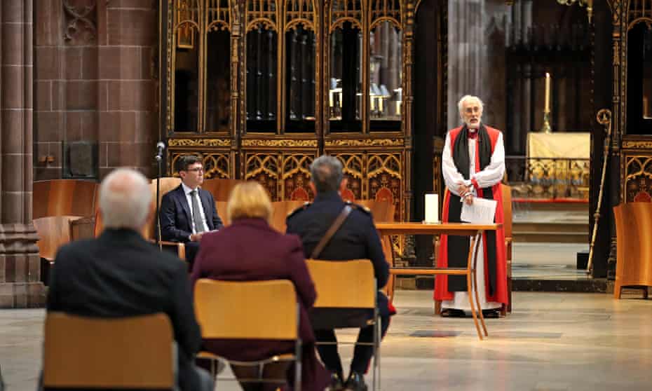 David Walker, bishop of Manchester, leading a memorial service for Covid victims alongside the mayor, Andy Burnham, at Manchester Cathedral last July.