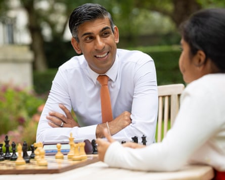 Rishi Sunak and Bodhana Sivanandan sitting in front of a chessboard in the garden on No 10