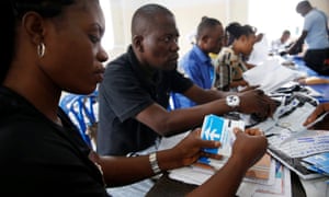 Officials count ballot paper