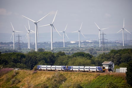 Frodsham windfarm in Cheshire with a train running past in front