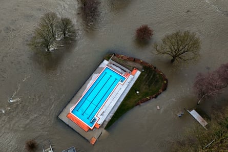 A swimming pool surrounded by flood waters