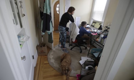 Rebecca Biernat watches as her son Seamus Keenan, 6, takes a live class online at their home in San Francisco.