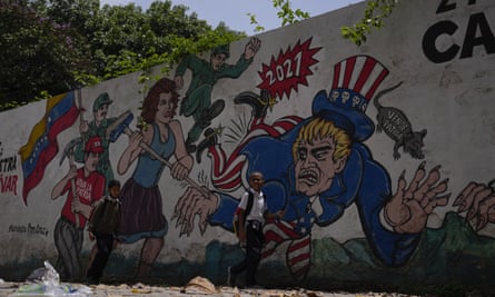 Children pass by a mural depicting Uncle Sam in Caracas this week.