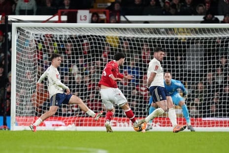 Wrexham's Liberato Cacace thumps the ball home to open the scoring against Nottingham Forest.