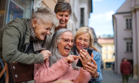 Group of happy senior women on a walk in city, taking selfie