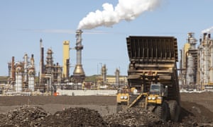 Massive dump trucks by the Syncrude tar sands upgrader plant in Alberta, Canada.