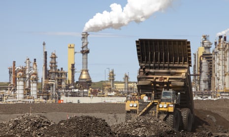 Massive dump trucks by the Syncrude tar sands upgrader plant in Alberta, Canada.