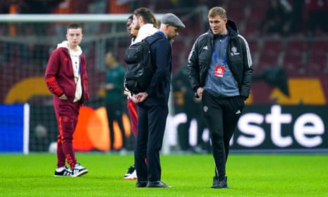 Erik ten Hag (left) and his assistant Darren Fletcher inspect the pitch.