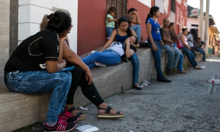 Elena Cruz and her mother, sit outside Comar in the Tapachula, seeking refugee status.