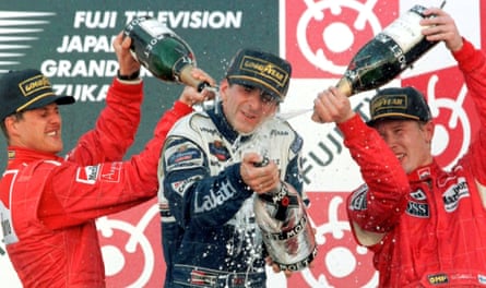 Damon Hill is doused in champagne by Michael Schumacher and Mika Häkkinen after winning the Japan Grand Prix at Suzuka to clinch the 1996 world drivers’ championship