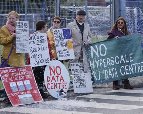 A group of protesters outside an event holding signs opposing datacentres