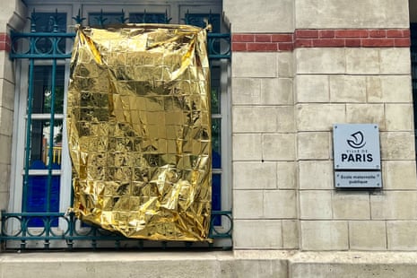 A survival blanket is seen on a school in an attempt to cool off after a week of heatwave in Paris. Soaring temperatures sweep across France in the second major heatwave of the year.
