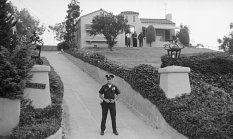 A police officer blocks the driveway while officers search the front of the house where Leno and Rosemary LaBianca were killed. 