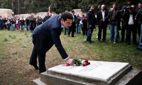 Alexis Tsipras leaves some flowers on a monument during a ceremony at the Kessariani shooting range site.