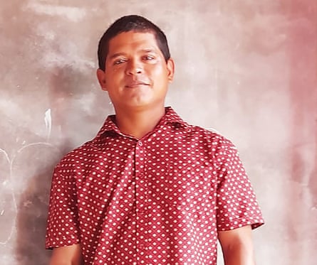 A young Indigenous Latin American man in a smart spotted shirt