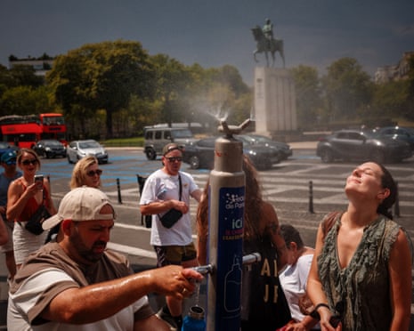 People gather around a public mist fountain in Paris