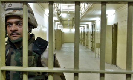A US soldier guards cells inside the prison of Abu Ghraib, outside Baghdad, Iraq, 5 May, 2004.