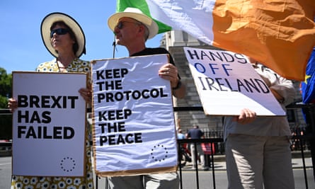 Protesters hold signs against the scrapping of the Northern Ireland protocol.