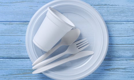 Disposable tableware and cutlery on blue wooden table, top view