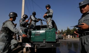 Afghan policemen arrive at the site of the suicide bombing.