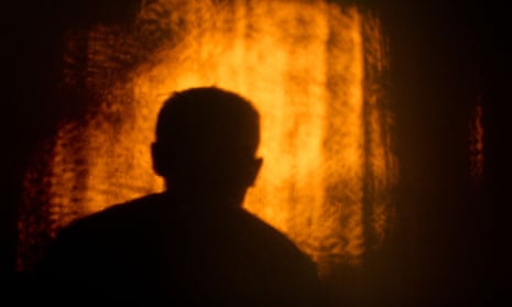 Silhouette of a man cast on a wall