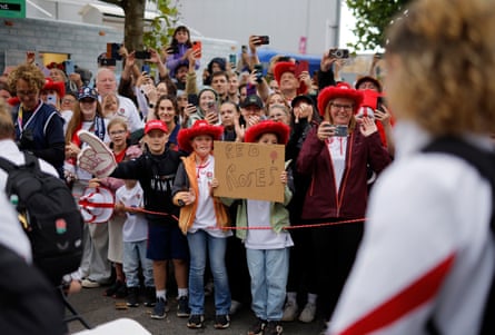 Red Roses fans welcome their England team including star player Ellie Kildunne (right) as they walk from the team bus into the stadium.