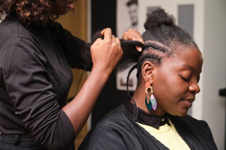 Hairdresser making crochet braids for a client in a hair salon
