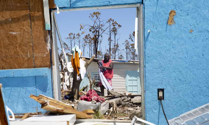 People dry clothes amid debris and rubble in Great Abaco, on 9 September.