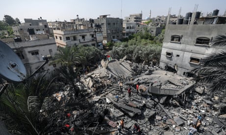 Palestinians inspect the rubble of the destroyed house of an Islamic Jihad member after Israeli airstrikes in the Gaza Strip