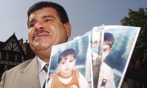 Daoud Mousa, father of Baha Mousa who was killed in British army custody in Basra in 2003, with photos of his grandchildren, 2004