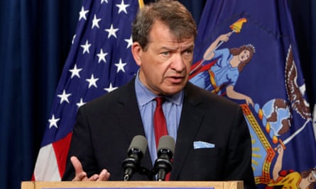 Man in suit and tie speaks at podium