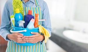 Person holding a bucket of cleaning supplies
