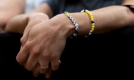 a woman’s wrist with a bracelet with beads spelling out harris