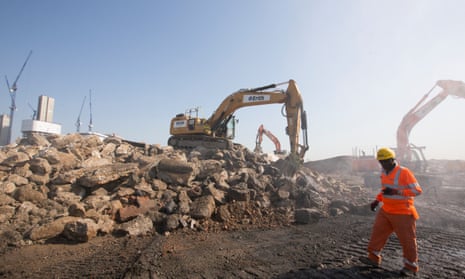 building site with rubble diggers and workman in hi-vis