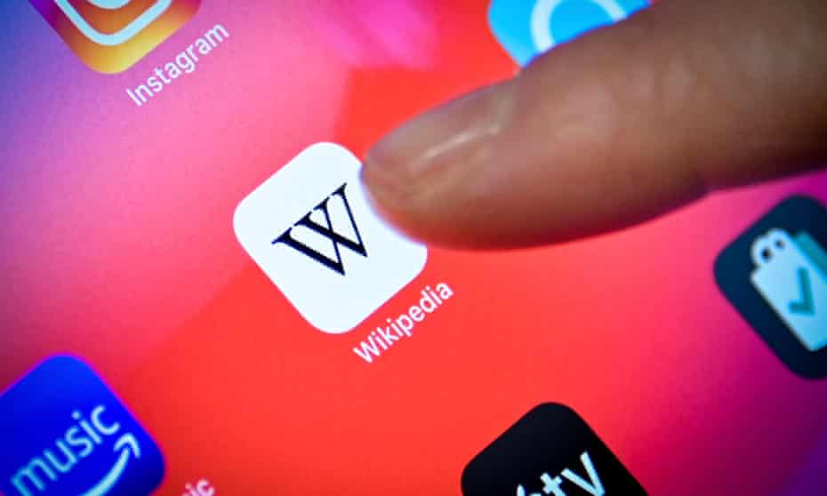 A close-up image shows a woman using the Wikipedia app on an iPad