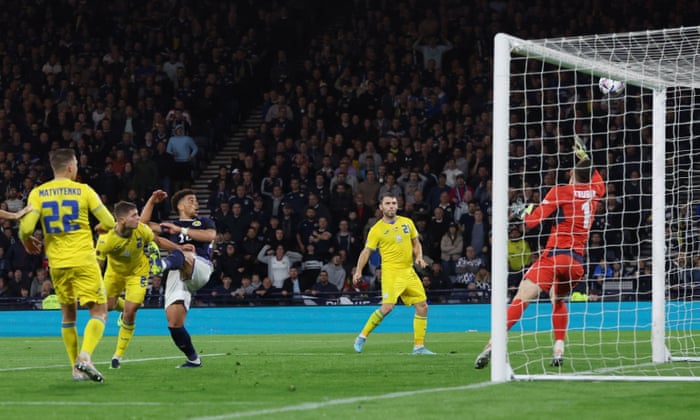 Scotland’s Che Adams reacts after his header comes off the bar.