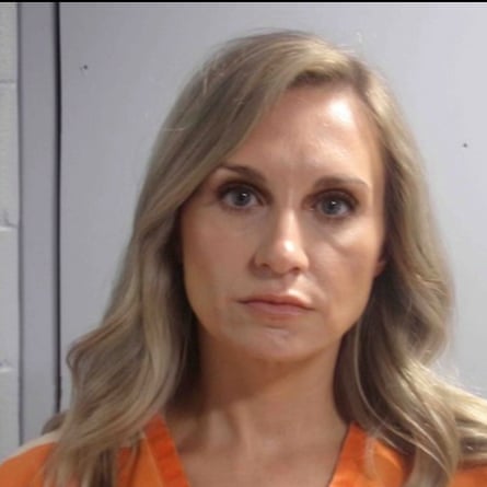 A woman looks into the camera for a mugshot