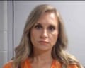 Mug shot of woman with long blond hair in orange shirt.