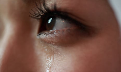 Woman with a tear rolling down cheek