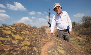 Professor Karim Sadr stands in front of stones that researchers believe were once the entrance to a household in the ancient city of Kweneng.