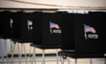 Black voting booths with American flags on the front