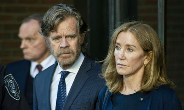Felicity Huffman exits a courthouse in Boston, Massachusetts, with her husband, William H Macy, on 13 September. 